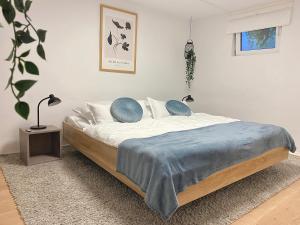 a bedroom with a bed with a blue blanket on it at 75qm mit eigenem Bad, Küche, Wohn- u Schlafzimmer in Herborn