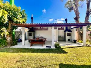 a house with a picnic table in the yard at Los Hermanos Residencial in Florianópolis