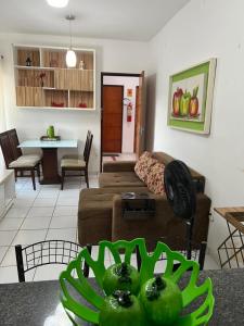 a living room with a couch and a table at APARTAMENTO CONFORTO in São Luís