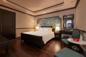 Postel nebo postele na pokoji v ubytování Sapa Soleil Hotel