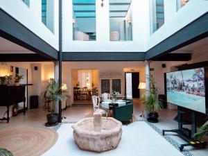 a large living room with a tv and a table at Finca Casabela in Pinos del Valle