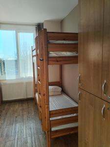 a room with two bunk beds and a window at Hostel Ferihegy in Vecsés