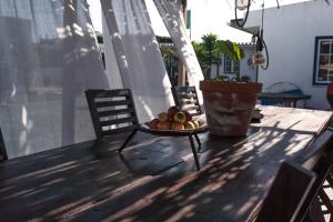 a bowl of fruit on a table on a porch at João Jungle in Açafora