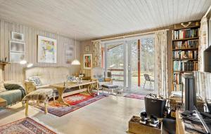 a living room with a couch and a table at 3 Bedroom Lovely Home In Nex in Vester Sømarken