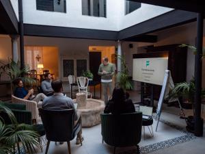 a man giving a presentation in front of a group of people at Finca Casabela in Pinos del Valle +104 photos