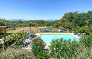 a swimming pool in a yard with chairs and trees at Alloro 2 in Montecarlo