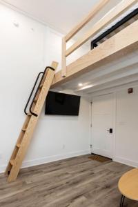 a loft bed in a room with a tv at Ocean Lofts in the Vibe #3 - 5 min walk to beach in Virginia Beach