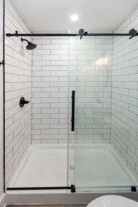 a bathroom with a shower with a glass door at Ocean Lofts in the Vibe #3 - 5 min walk to beach in Virginia Beach