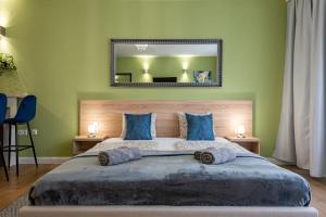 a bedroom with a large bed with blue pillows at Budapest Holidays Apartments & Spa in Budapest