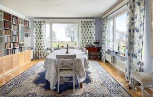 a dining room with a table and a large window at Lovely Home In Slite With Wifi in Slite