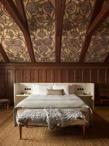 a bedroom with a large bed with wooden walls at Ett Hem in Stockholm