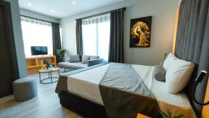 a bedroom with a bed and a couch and a chair at ViparkOtel&Spa in İskenderun