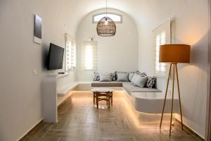 a living room with a couch and a table at City Center Suites in Fira