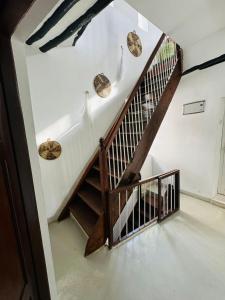 a staircase in a house with rocks on the wall at Seafarers Loft in Stone Town