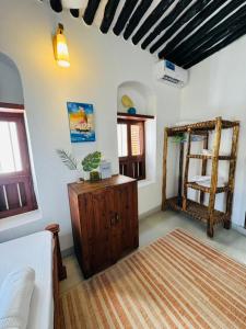 a living room with a bed and a mirror at Seafarers Loft in Stone Town