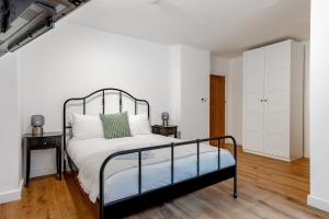 1 dormitorio con 1 cama y 2 mesitas de noche en Charming Large Studio in Hampstead, en Londres