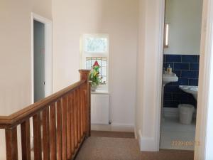 a hallway with a stairway leading to a bathroom at Bryn Mair in Barmouth in Barmouth