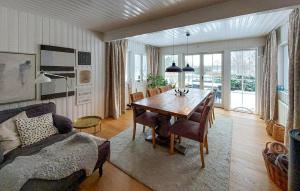 a living room with a dining room table and a couch at Beautiful Home In Hjrnarp With Jacuzzi in Hjärnarp