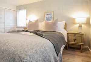 - une chambre avec un grand lit et des oreillers blancs dans l'établissement Sea Spray - Bracklesham Bay, à Chichester