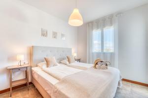 a bedroom with a large bed with a teddy bear on it at Traumhafte Villa Maricel für 8 Gäste am Meer in Alcudia