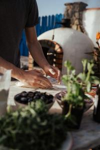 a man is preparing food in front of an oven at João Jungle in Açafora