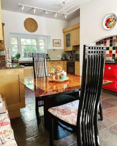 a kitchen with a wooden table and two chairs at Marlacoo House Luxury Georgian home in Portadown