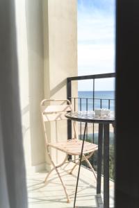 a table and a chair on a balcony at Boutique Apartments Marsol Ibiza in Santa Eularia des Riu