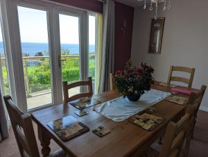 a dining room table with a view of the ocean at Elmbank house in Spittal