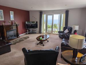 a living room with leather furniture and a fireplace at Elmbank house in Spittal