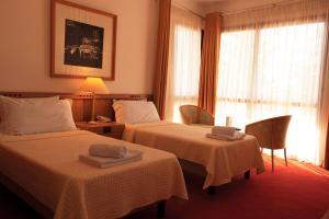Postel nebo postele na pokoji v ubytování Chateau Linza Resort