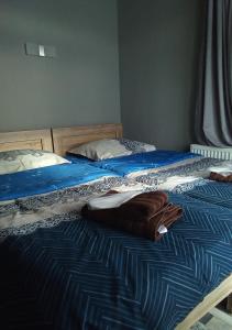 two beds in a bedroom with towels on them at Mountain Dream House in Gudauri