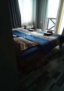a pair of beds in a room with a window at Mountain Dream House in Gudauri