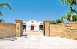 una casa con una pared de piedra y una puerta en Villa Perla Salentina luxury, en Taviano