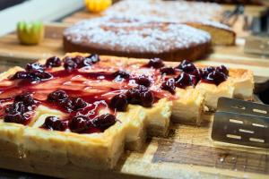 a pie with cherries on it sitting on a table at Trypiti Resort Blue Dream Palace and Hive Water Park in Limenaria
