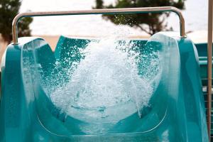 a blue water slide at a water park at Trypiti Resort Blue Dream Palace and Hive Water Park in Limenaria