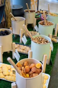 a table with buckets filled with different types of food at Trypiti Resort Blue Dream Palace and Hive Water Park in Limenaria