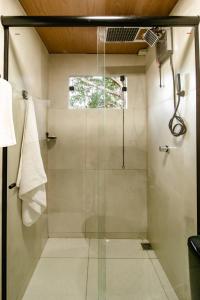a shower with a glass door in a bathroom at My Home Alter in Alter do Chao