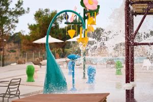 a water park with a fountain in the middle at Trypiti Resort Blue Dream Palace and Hive Water Park in Limenaria