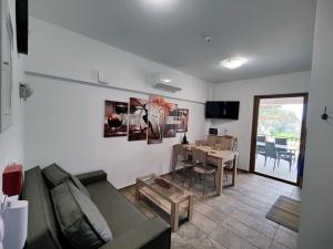 a living room with a couch and a table at ArokariApartments in Koroni