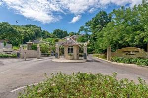 a building on a street next to a road at Hospitality Expert Eden 7BR Pools Beach in Montego Bay +128 photos