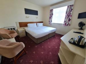 Katil atau katil-katil dalam bilik di Norfolk Hotel