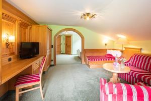 a living room with a red couch and a table at Birgsau in Oberstdorf