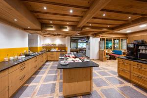 a large kitchen with wooden cabinets and a large island at Birgsau in Oberstdorf