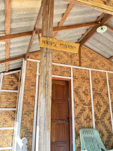 a wooden sign that reads happy rookie next to a door at Sofee Homestay(Bulone Island),Thailand in Ko Bulon Le