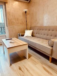 a living room with a couch and a table at Cherry JACUZZI Apartment in Ronda