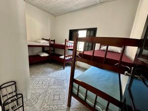 Casa aconchegante em Peruíbe في بيرويبي: غرفة مع ثلاثة أسرة بطابقين في غرفة