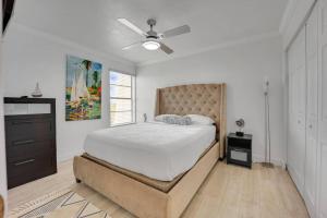 a bedroom with a bed and a ceiling fan at Overlooking Saltwater Lagoon Free Golf Cart-Kayaks in Key Largo