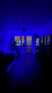 a living room with blue lights in a room at Kato Flat Center in Katowice