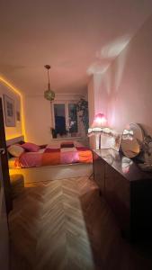 a bedroom with a bed and a table with a lamp at Kato Flat Center in Katowice