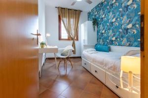 a bedroom with a bed and a desk and a window at Emilia - Elegant and Modern Apartment in Rome